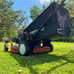 Rear-angle shot of Titan Pro zero-turn mower, highlighting one-touch height adjustment lever and large 80?L grass catcher.
